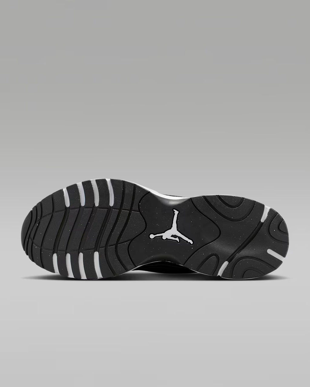 Black sneaker with a white logo on a gray background