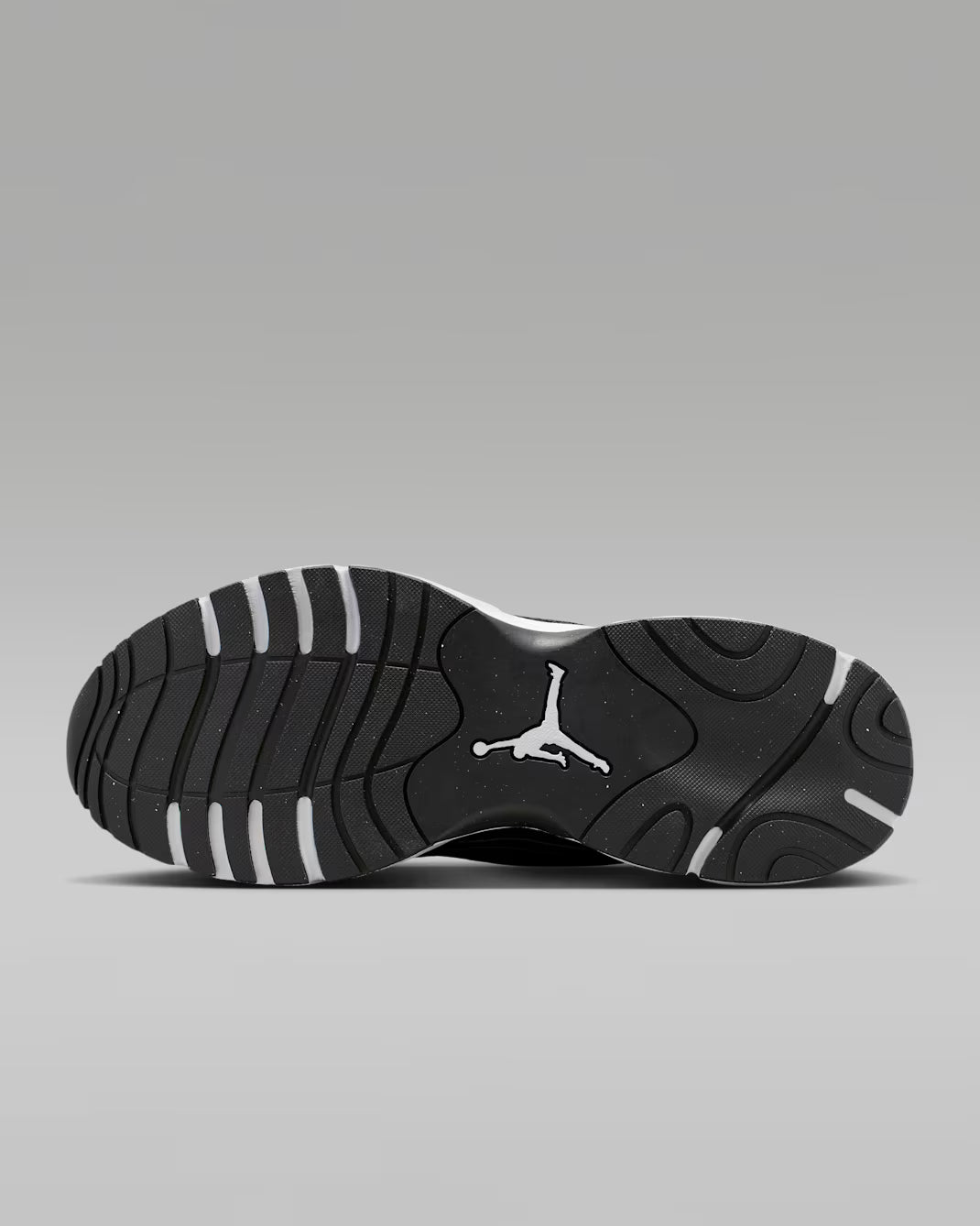 Black sneaker with a white logo on a gray background