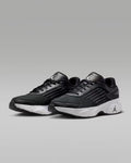 Black athletic shoes with a brand logo on a gray background